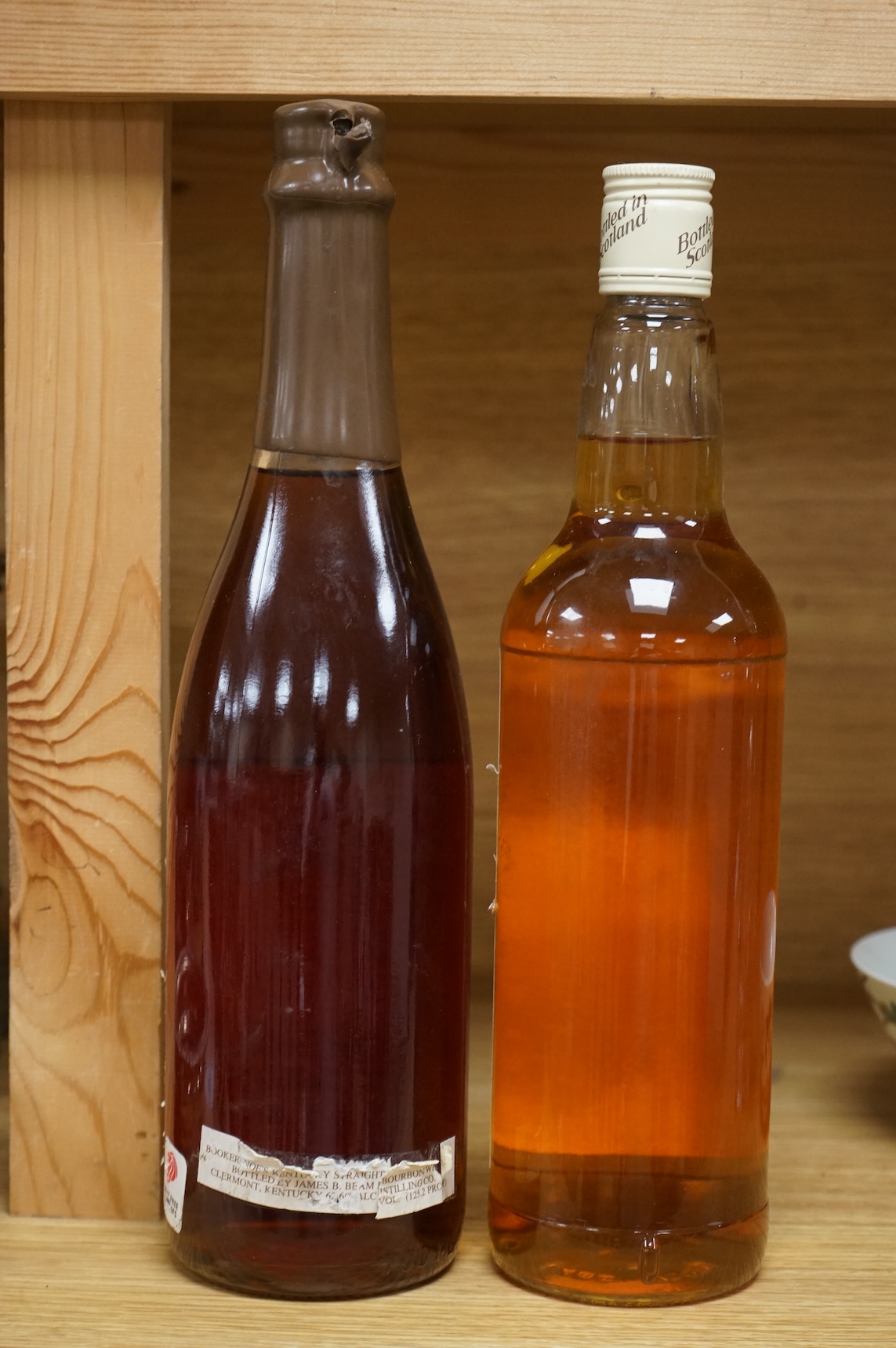 A bottle of ‘Daily Mirror’ Famous Grouse whisky and a bottle of Booker Noe’s Kentucky Bourbon Whiskey, bottled by James B. Beam Distilling Co.